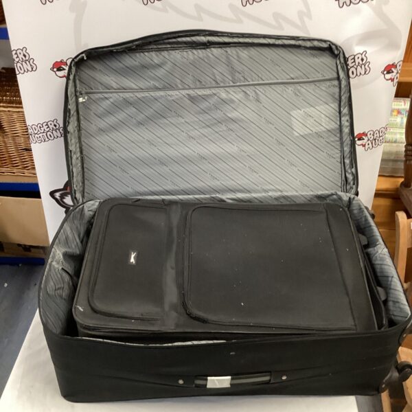 Black Slazenger wheeled suitcase open, showing interior space.