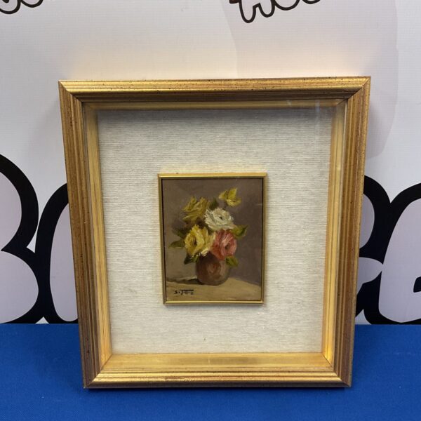 Antique miniature oil painting of flowers in a gilt frame.