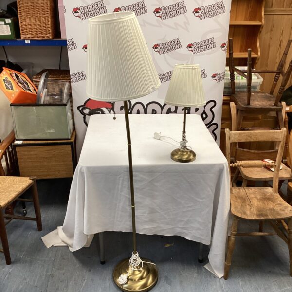 Vintage brass standard lamp with lampshade on a white background.