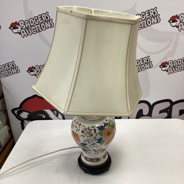 Vintage oriental ceramic table lamp with detailed design.