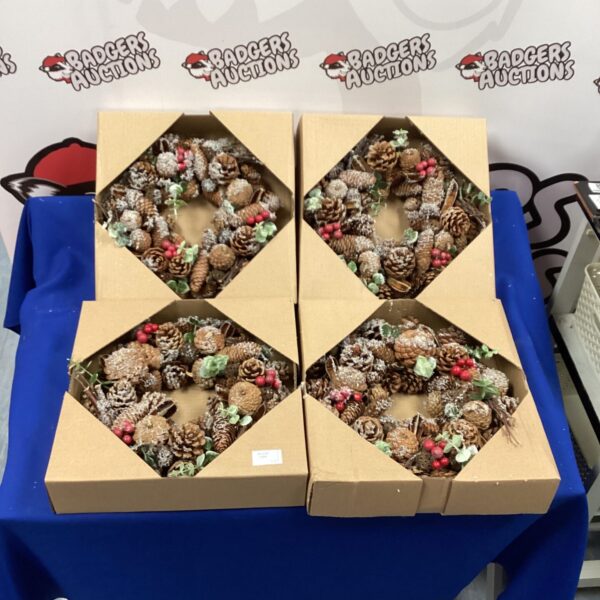 Boxed lot of four Christmas wreaths with pinecones and berries.