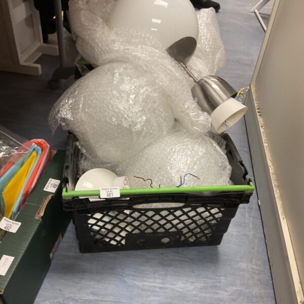 Crate filled with white circular lights for lighting projects.