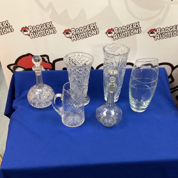 Vintage crystal vases and decanters in a decorative lot.