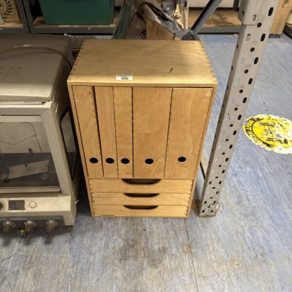 Vintage wooden filing cabinet with multiple drawers for office storage.