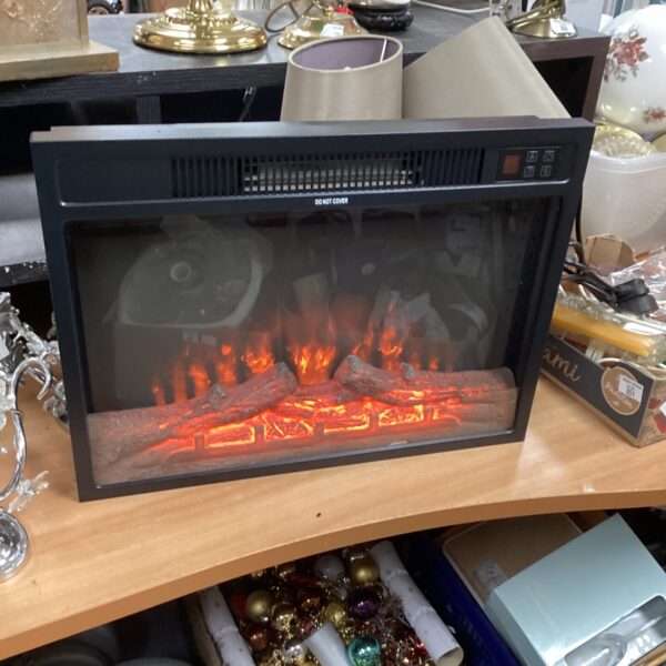 New boxed electric fireplace with remote control for home heating.