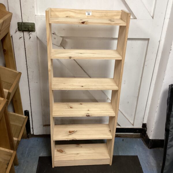 Four-shelf pine bookcase, rustic wooden storage solution.