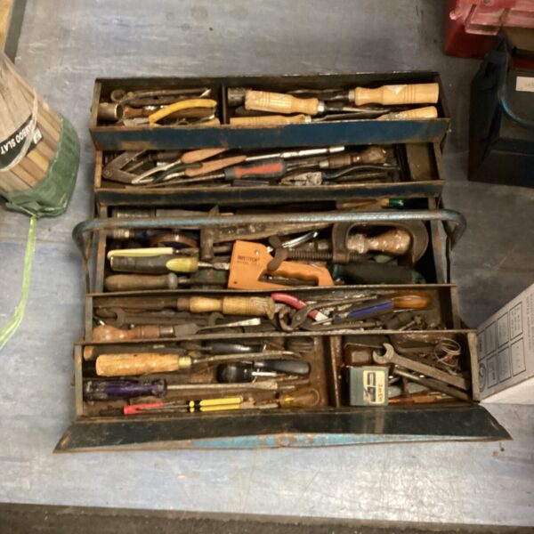 Open vintage cantilever toolbox filled with various tools.