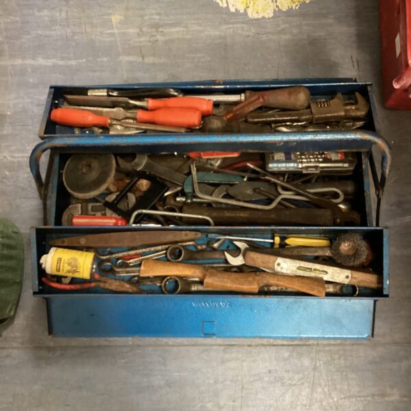 Vintage cantilever toolbox filled with various hand tools.