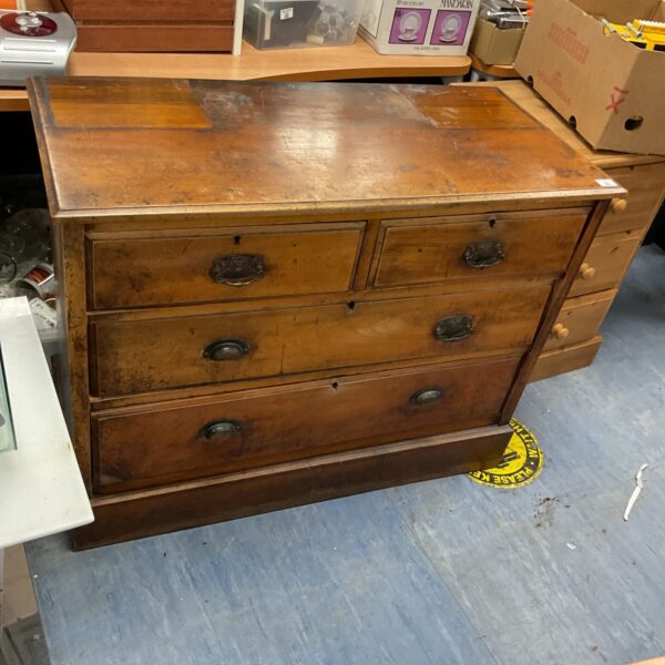 Antique 2 over 2 chest of drawers with warm wood finish.