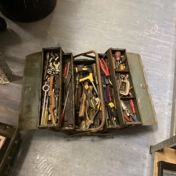 Vintage cantilever tool box open with tools inside.