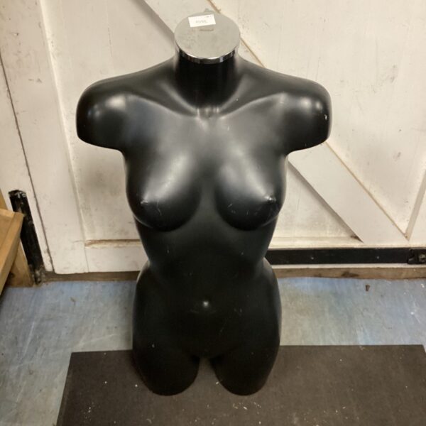Black plastic mannequin torso for clothing display.