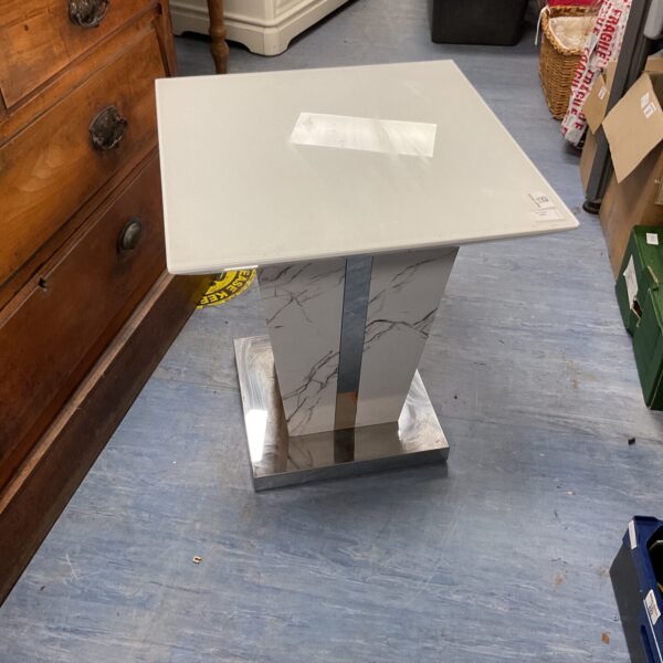 Modern pedestal table with marble effect top and chrome base.