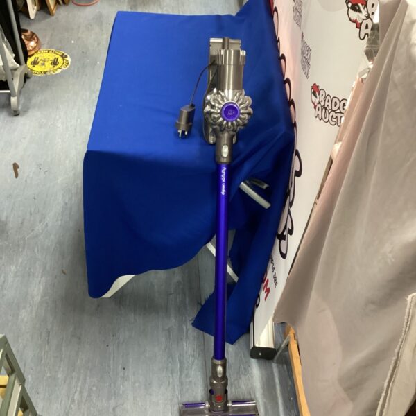 Purple Dyson V8 cordless stick vacuum cleaner for home cleaning.