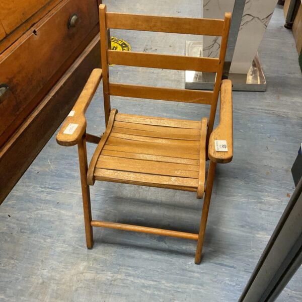 Vintage wooden folding child's chair with slatted seat.