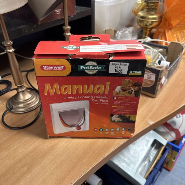 Front view of a used Petsafe manual four way cat flap.
