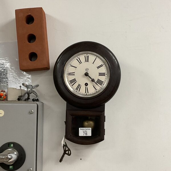 Front view of a vintage Victorian wall clock with Roman numerals.