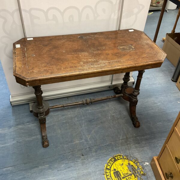 Antique walnut console table with carved legs and shaped top.