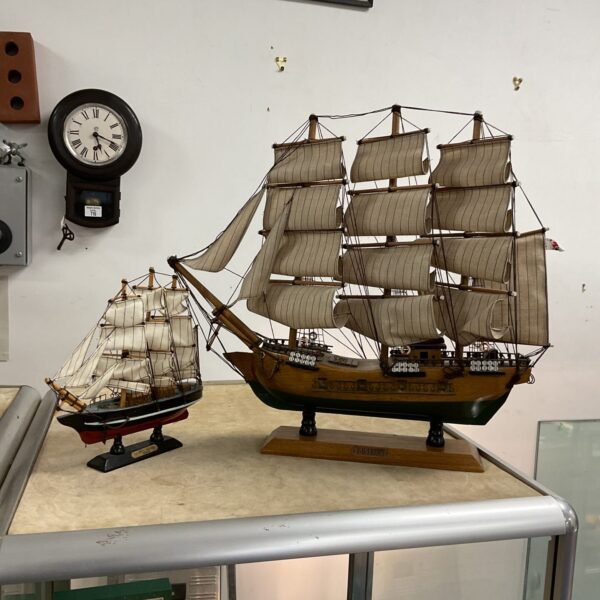 Vintage wooden model ships HMS Bounty and Cutty Sark on display.