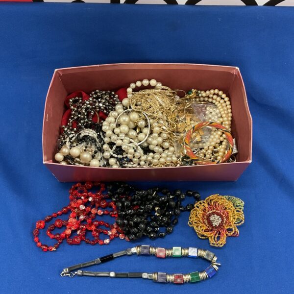 Assorted costume jewellery lot with red bead necklace.