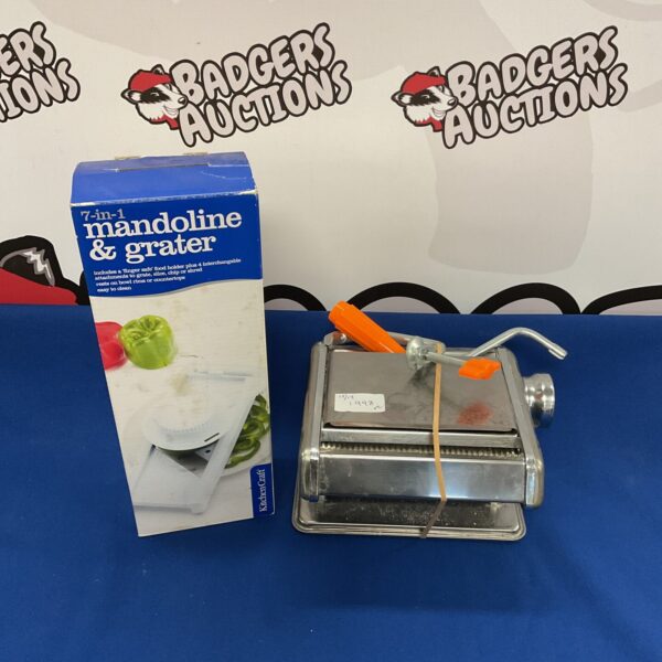 Stainless steel pasta maker and mandoline slicer kitchen tool.