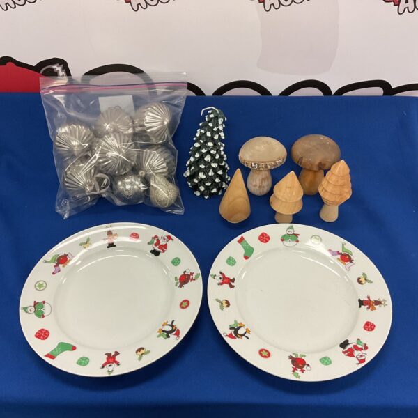 Vintage Christmas plates and a selection of festive ornaments.