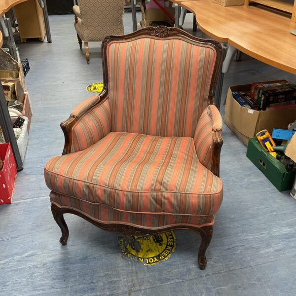 Front view of a striped French Louis XV armchair.