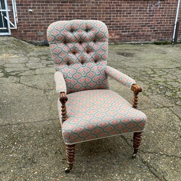 Front view of a patterned Victorian barley twist armchair.