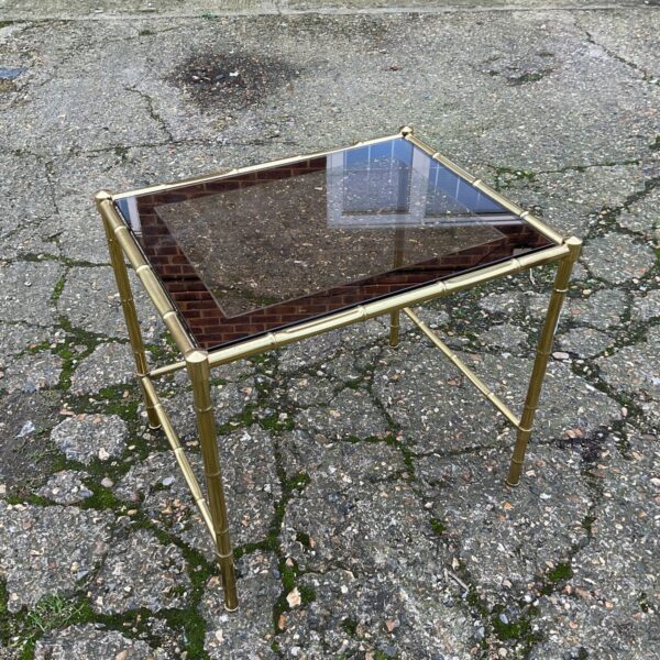 Vintage brass magazine table with glass top and bamboo design.
