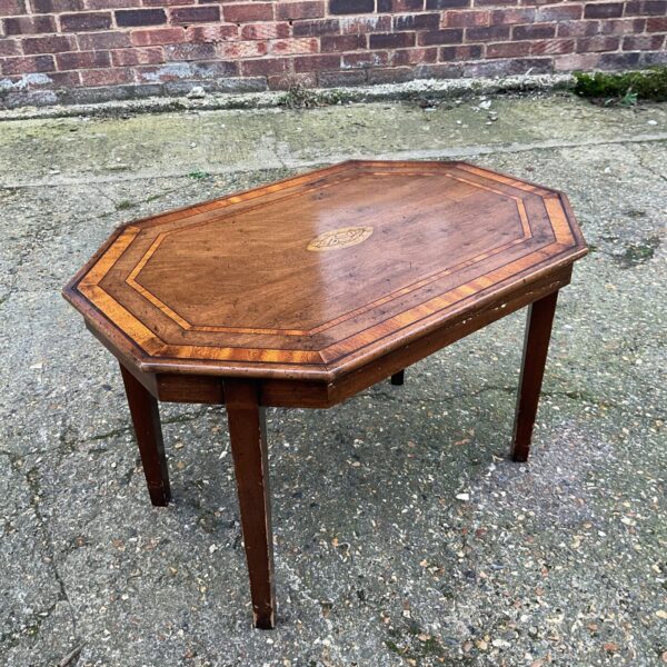 Close-up of inlaid detail on antique mahogany table.