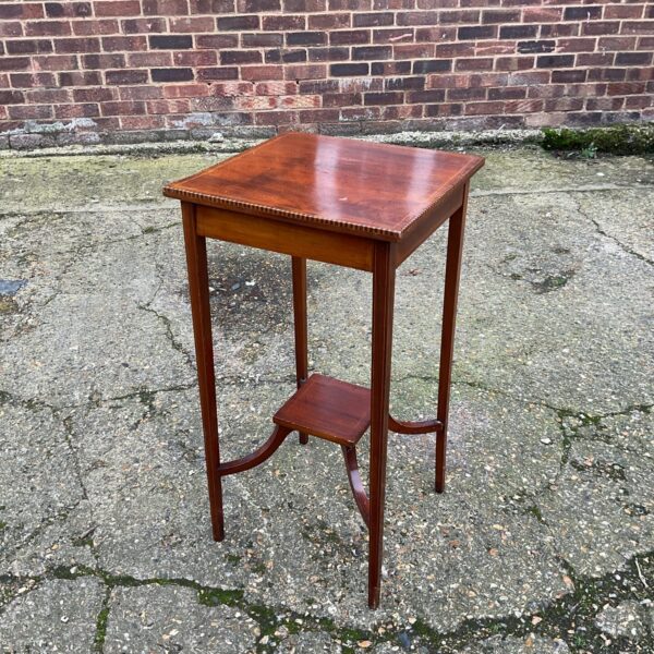 Elegant Edwardian mahogany lamp table with inlaid details.