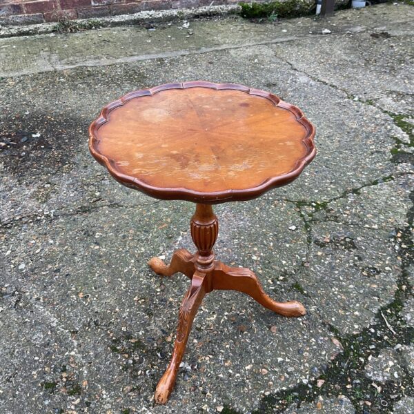 Antique mahogany pie crust wine table with tripod legs.