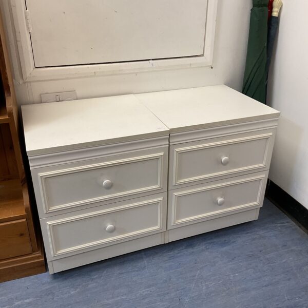 Pair of white bedside cabinets with two drawers.