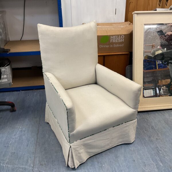Reupholstered Victorian armchair in a light-coloured fabric.
