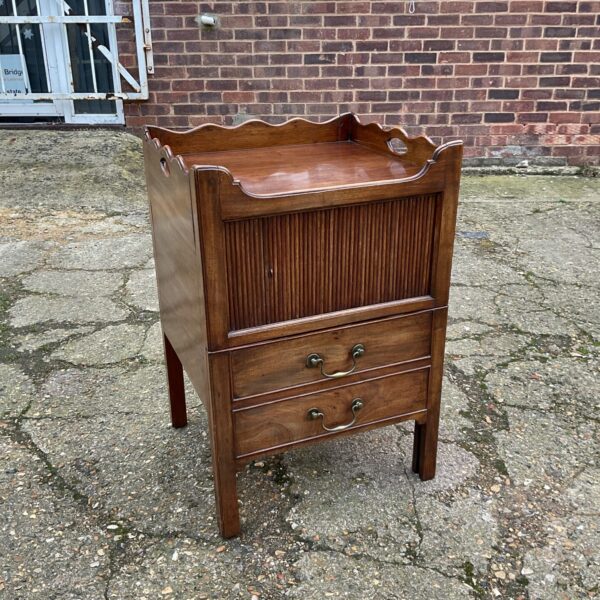 Antique Georgian mahogany commode with tray top and roll front.
