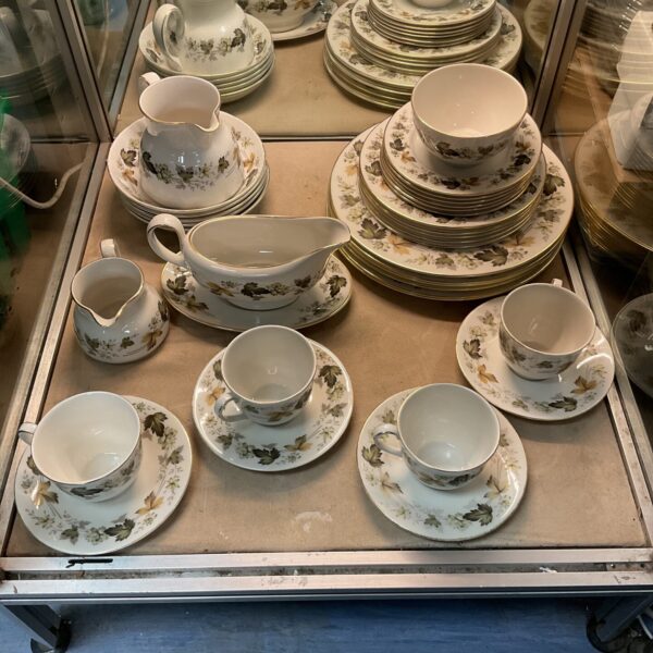 Royal Doulton Larchmont china collection displayed on a shelf.