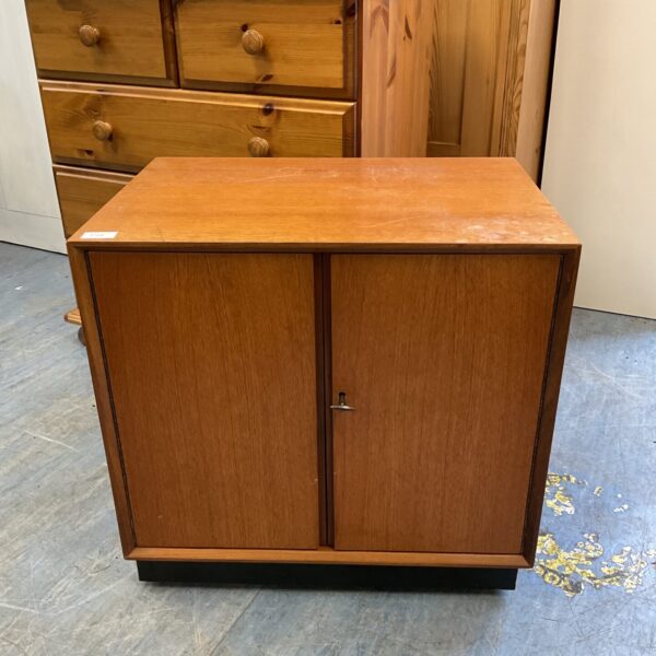 Front view of a mid-century modern record cabinet in warm wood tones.