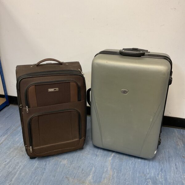 Dark brown Airtec and grey Beverly Hills Polo Club travel suitcases.