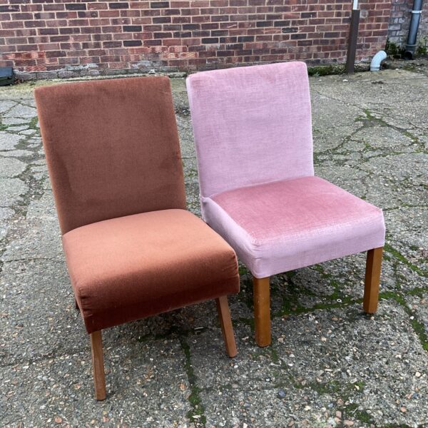 Pair of vintage mid-century nursing chairs with wood legs.