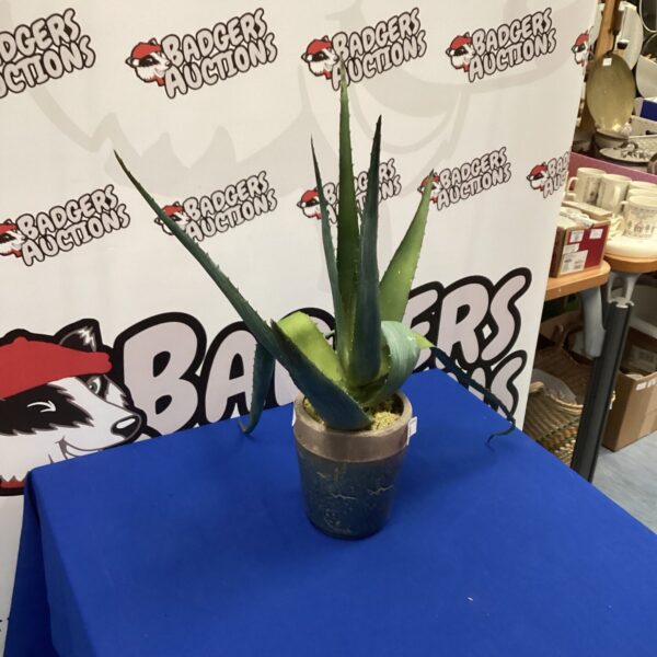 Realistic artificial aloe vera plant in terracotta pot for home decor.