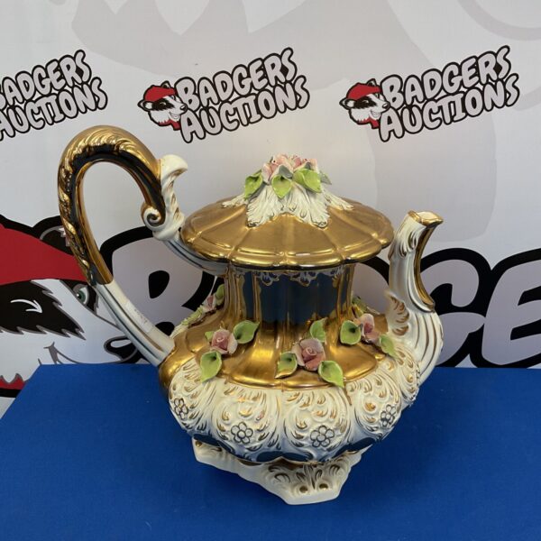 Large Italian majolica teapot with floral and gilt decoration.