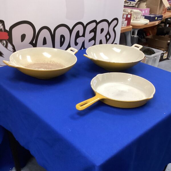 Vintage cast iron cookware lot including frying pan and casserole dishes.