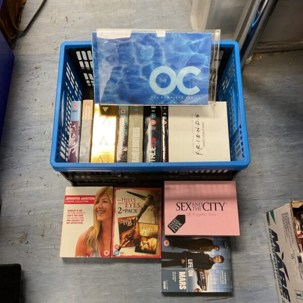 Blue container filled with DVD box sets including The OC.