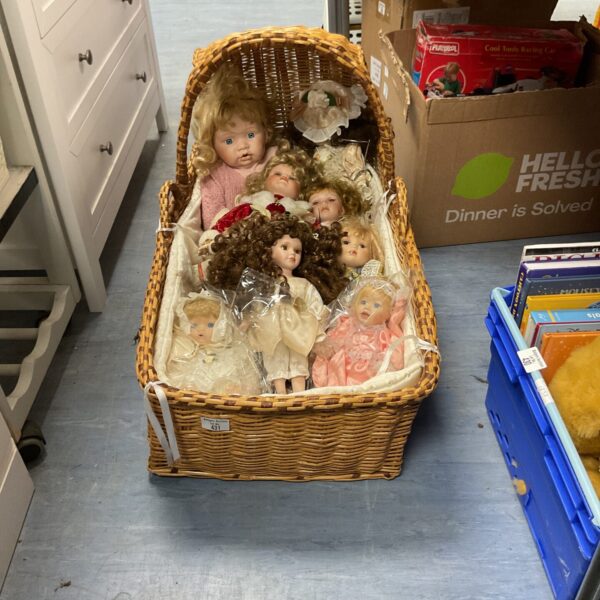 Vintage dolls lot in a wicker basket, antique collectible toys.