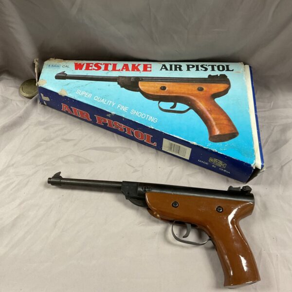 Vintage Westlake .22 caliber air pistol in original packaging.