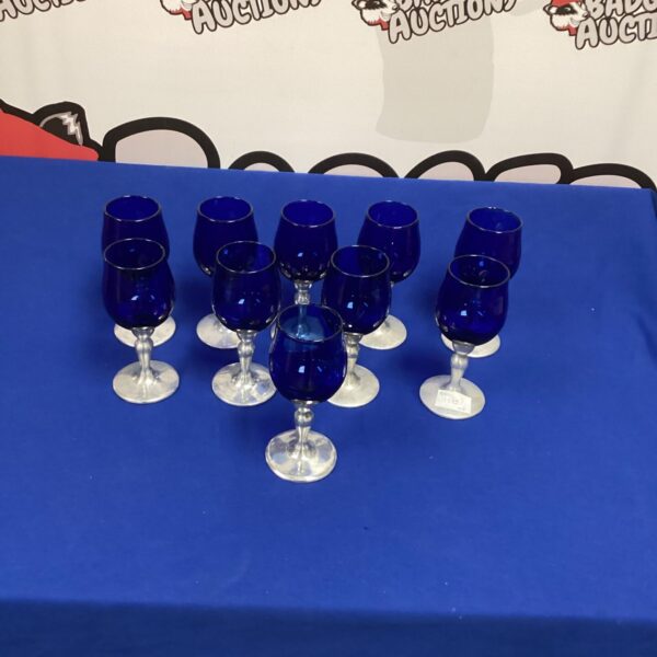 Set of ten vibrant blue wine glasses with aluminium stems.