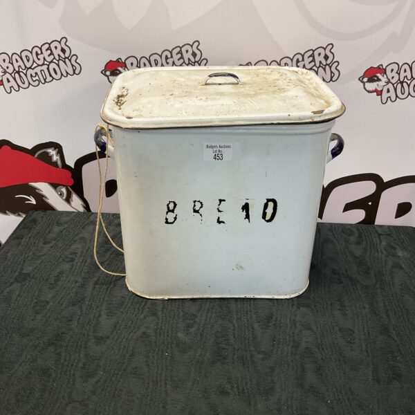 White vintage enamel bread bin with roll-top lid.