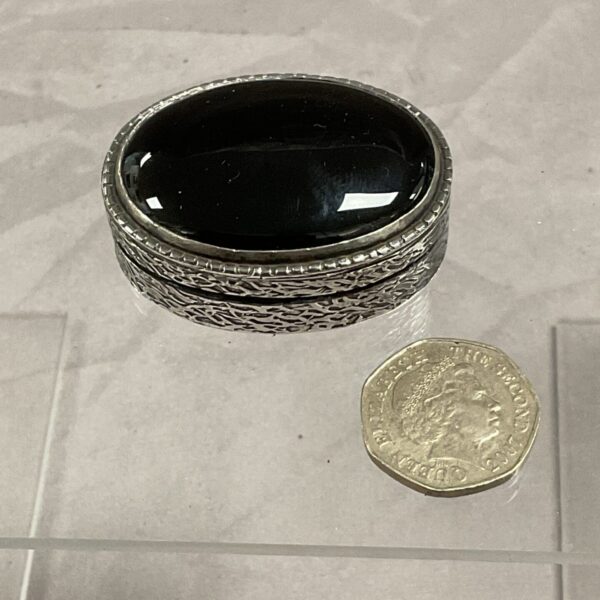 Antique silver pill box with black onyx inlay.