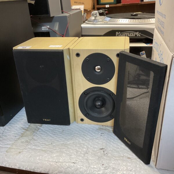 Pair of black Teac LS-303U bookshelf speakers presented in images.