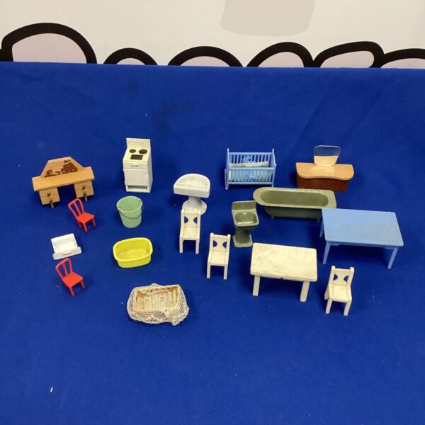 Vintage dolls house furniture collection with miniature chairs and tables.