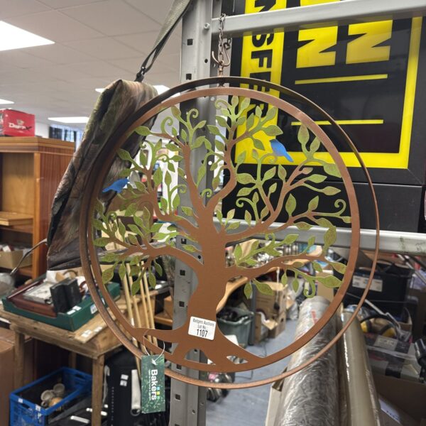 Intricate metal Bakers garden tree ornament for outdoor decoration.